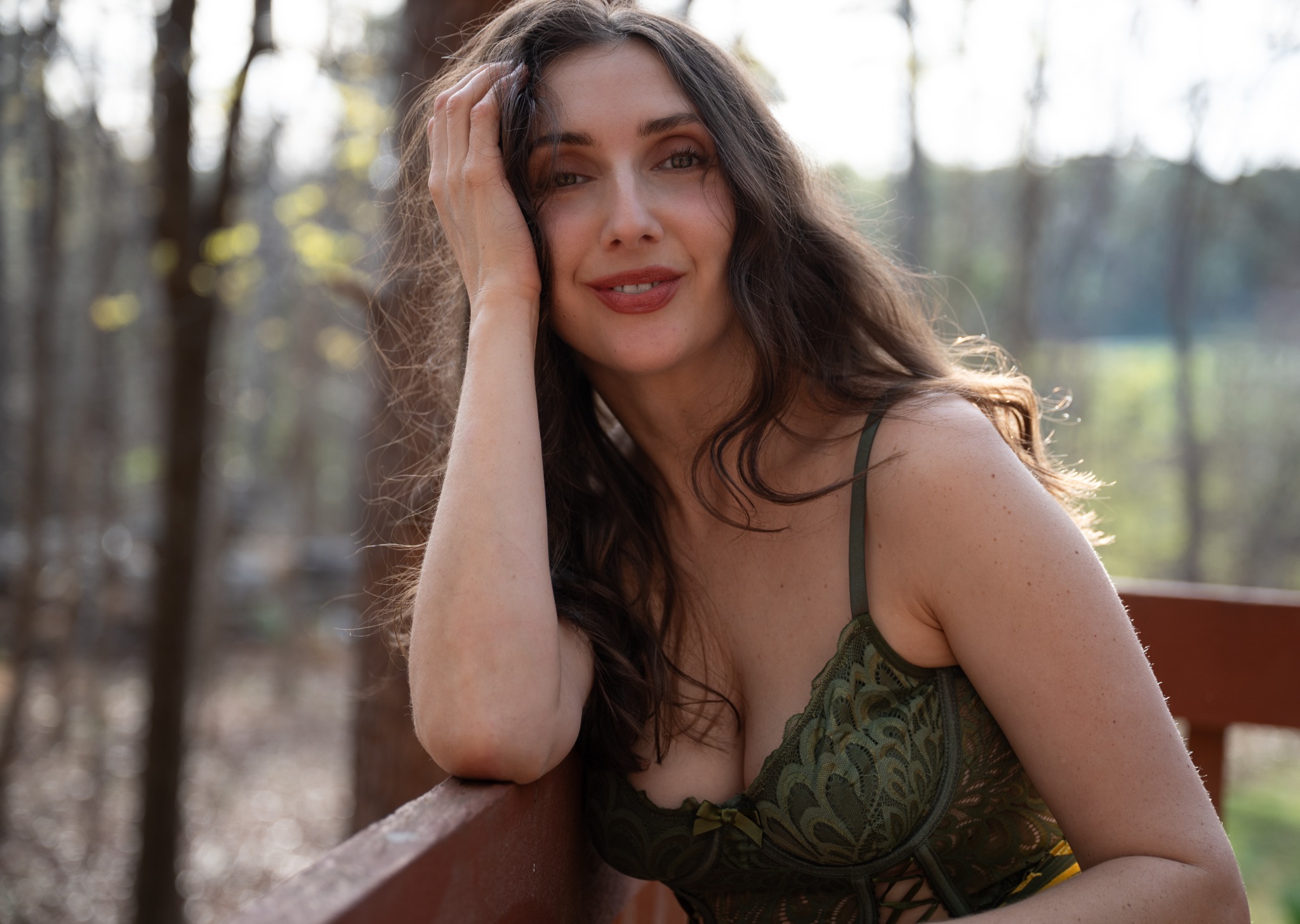 Natural-light outdoor portrait of a brunette in green lace
